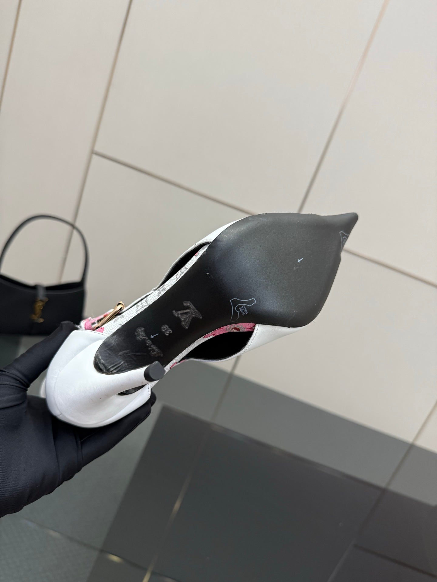 Louis Vuitton women's ankle boot sole view with black heel and logo markings