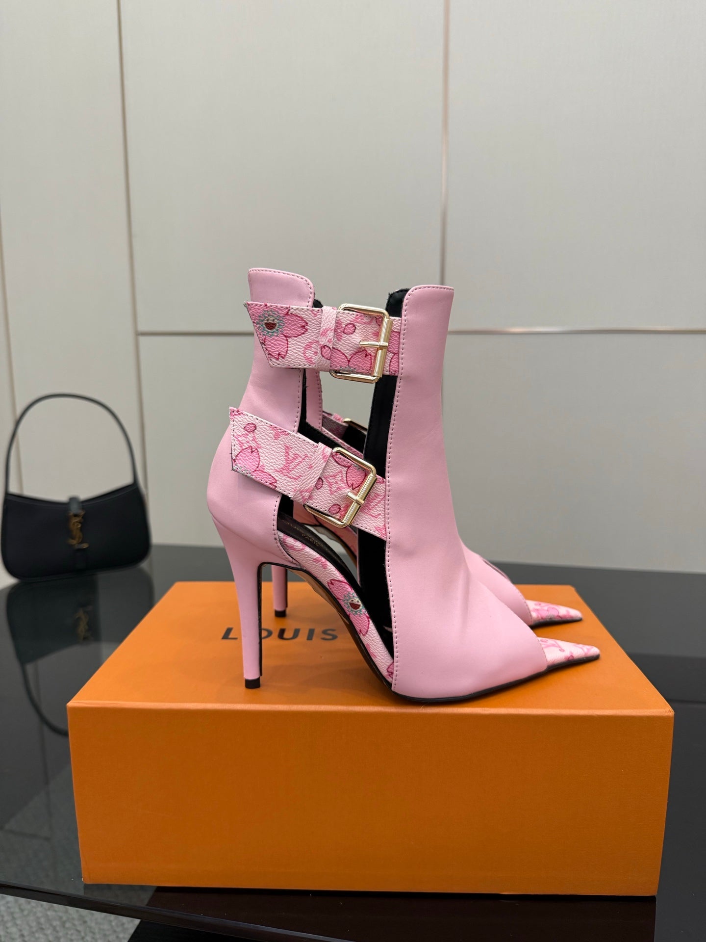 Women's Louis Vuitton pink ankle boot with gold buckle straps and patterned trim