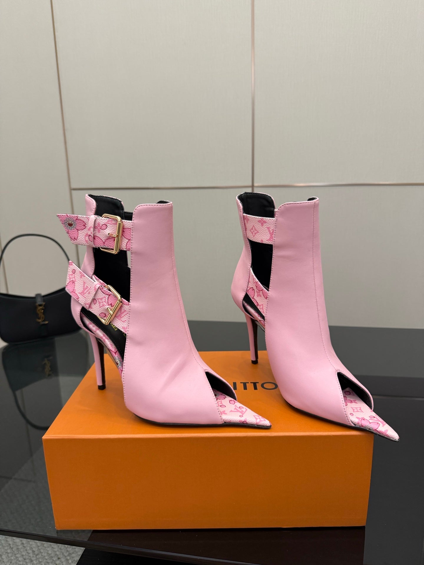 Women's Louis Vuitton pink ankle boots with patterned panels and gold buckles