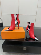 Red ankle boots with multicolor patterned lining on collar; gold hardware and stiletto heel