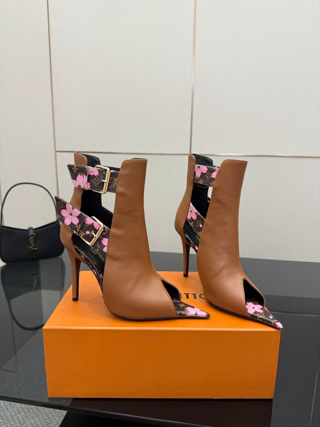 Women's Louis Vuitton ankle boots with tan uppers and pink flower print on black panels.