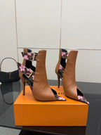 Women's Louis Vuitton ankle boots with tan uppers and pink flower print on black panels.