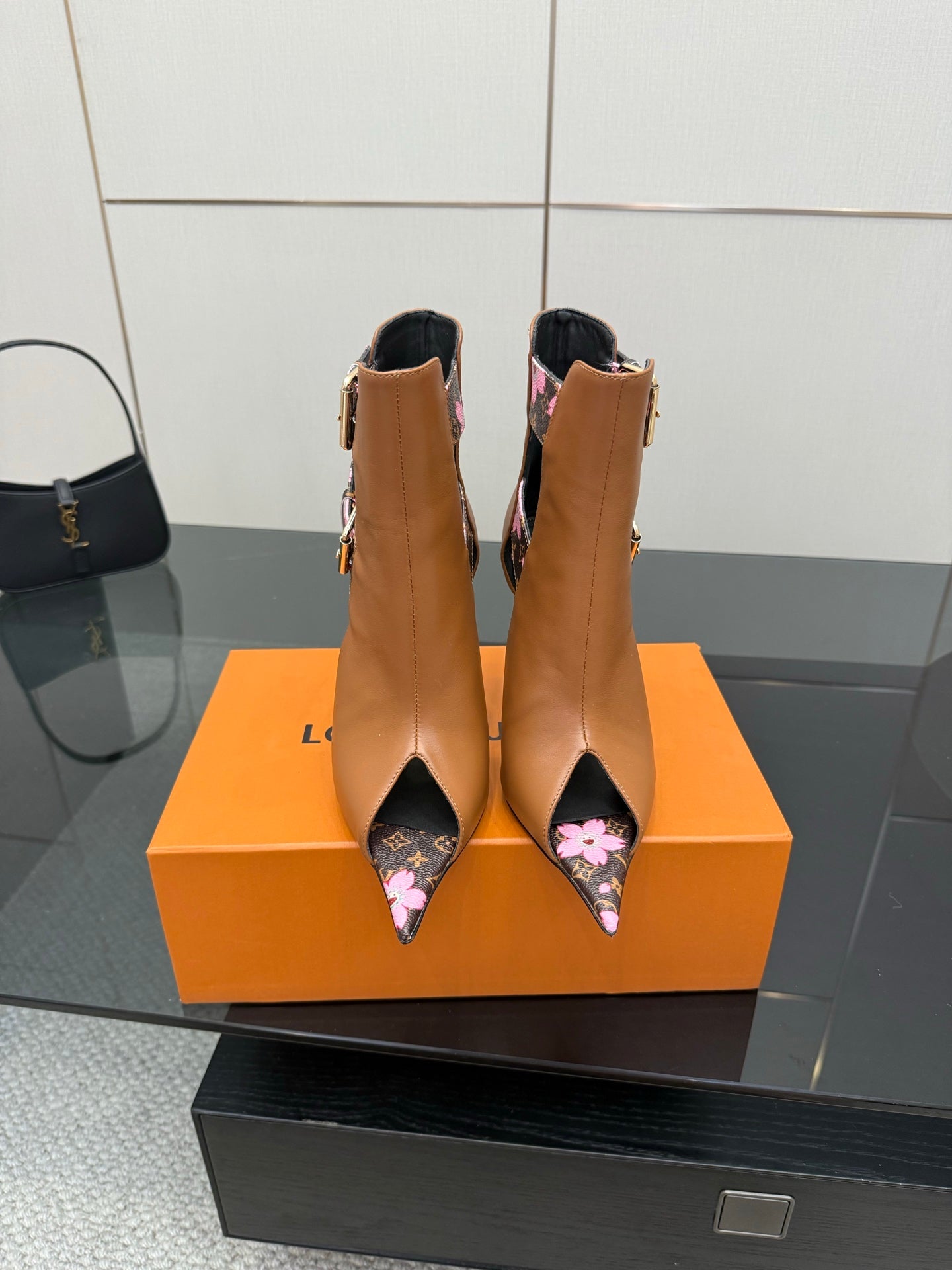 Women's Louis Vuitton ankle boots, tan leather with black floral straps and high heel.