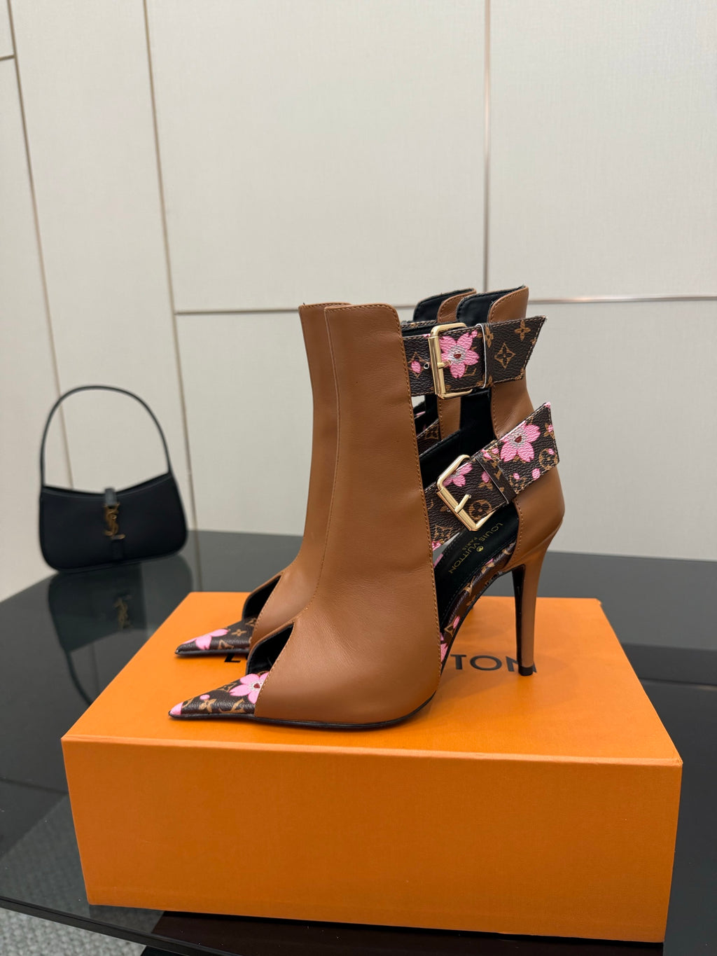 Women's Louis Vuitton ankle boots, tan leather with black floral wrap and stiletto heel.