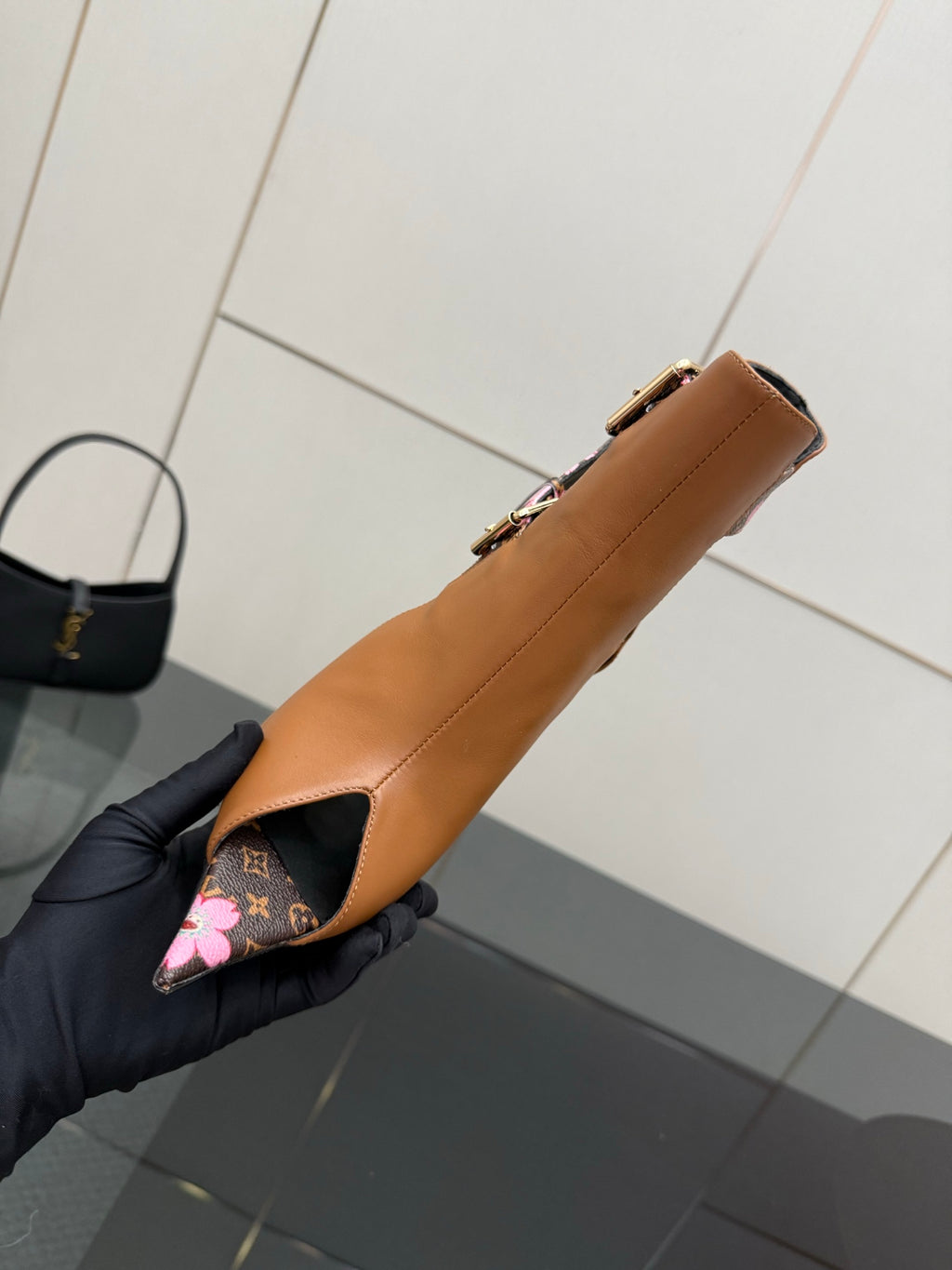Women's Louis Vuitton ankle boot, tan leather side view with pink floral underlay.
