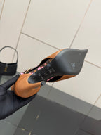Women's Louis Vuitton ankle boot heel, tan leather with black sole and pink floral trim.