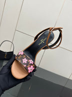 Louis Vuitton slingback sandal detail, black floral monogram strap and tan insole