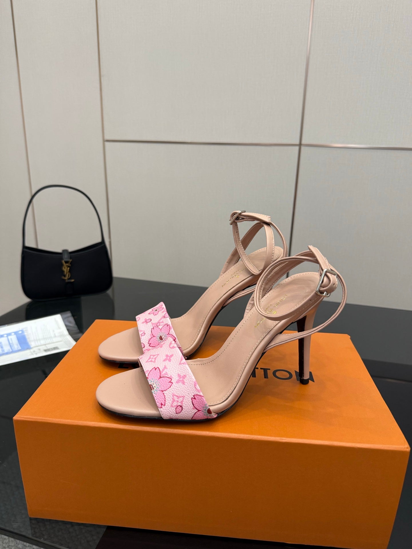 Heeled sandals with nude straps and pink patterned toe band on high stiletto heels