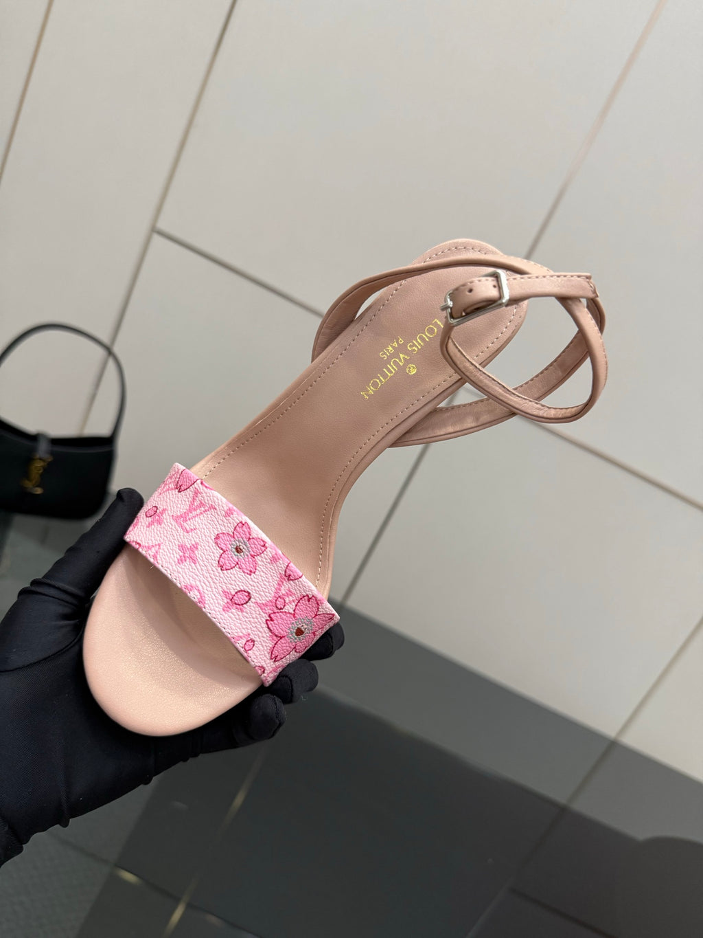 Nude heeled sandal close-up with pink patterned ankle strap and cross-strap detail