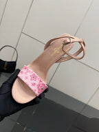 Nude heeled sandal close-up with pink patterned ankle strap and cross-strap detail