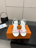 Women's heeled sandals in white with pink floral straps, stiletto heel and ankle ties