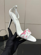 Women's white slingback heeled sandal with pink floral wrap and thin stiletto heel