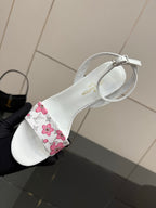 Women's white sandal with pink floral strap and circular ankle buckle detail