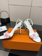 Women's white slingback sandals with pink floral side panels and stiletto heel