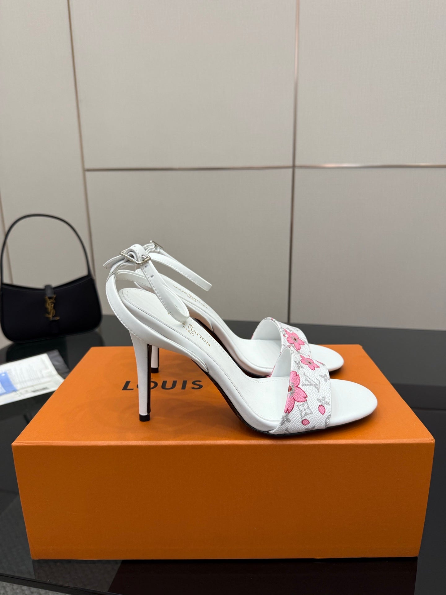 Women's white heeled sandals with pink floral ankle straps and thin stiletto heel