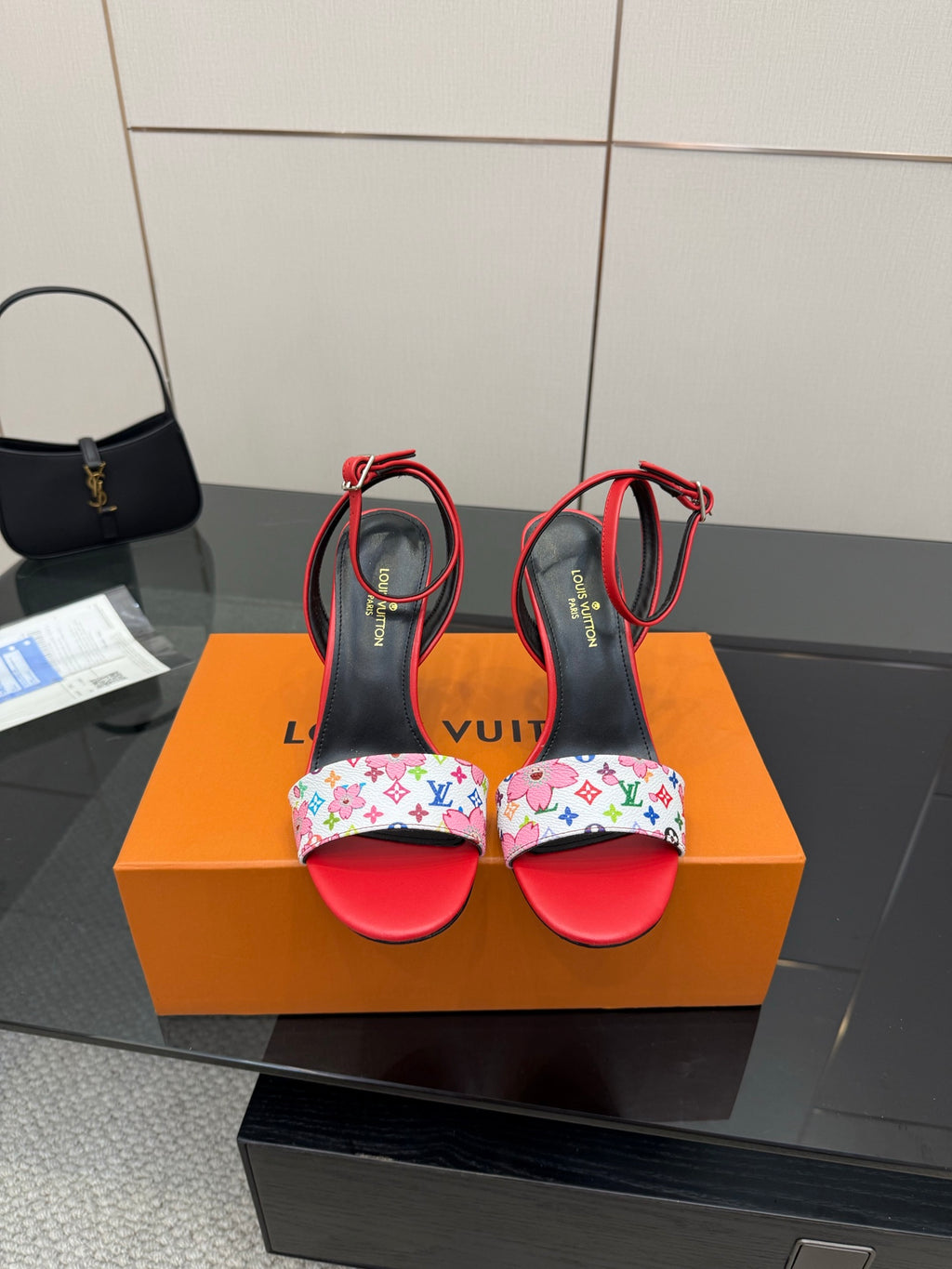 Louis Vuitton women’s high-heel sandals with red straps, black base, and floral-pattern toe band