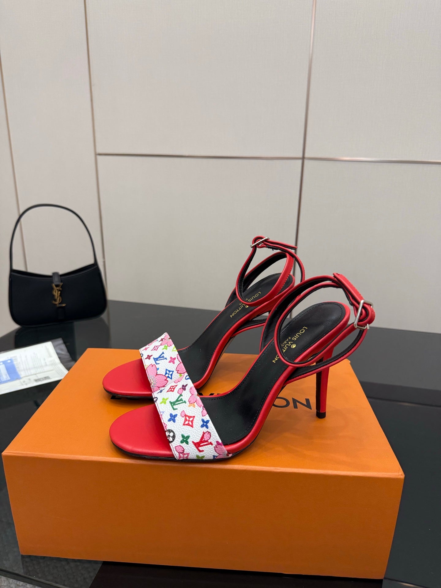 Louis Vuitton women’s heeled sandals in red and black with floral-pattern crossover straps