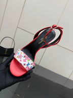 Louis Vuitton women’s red sandal with black heel and floral-pattern strap detail shown close-up