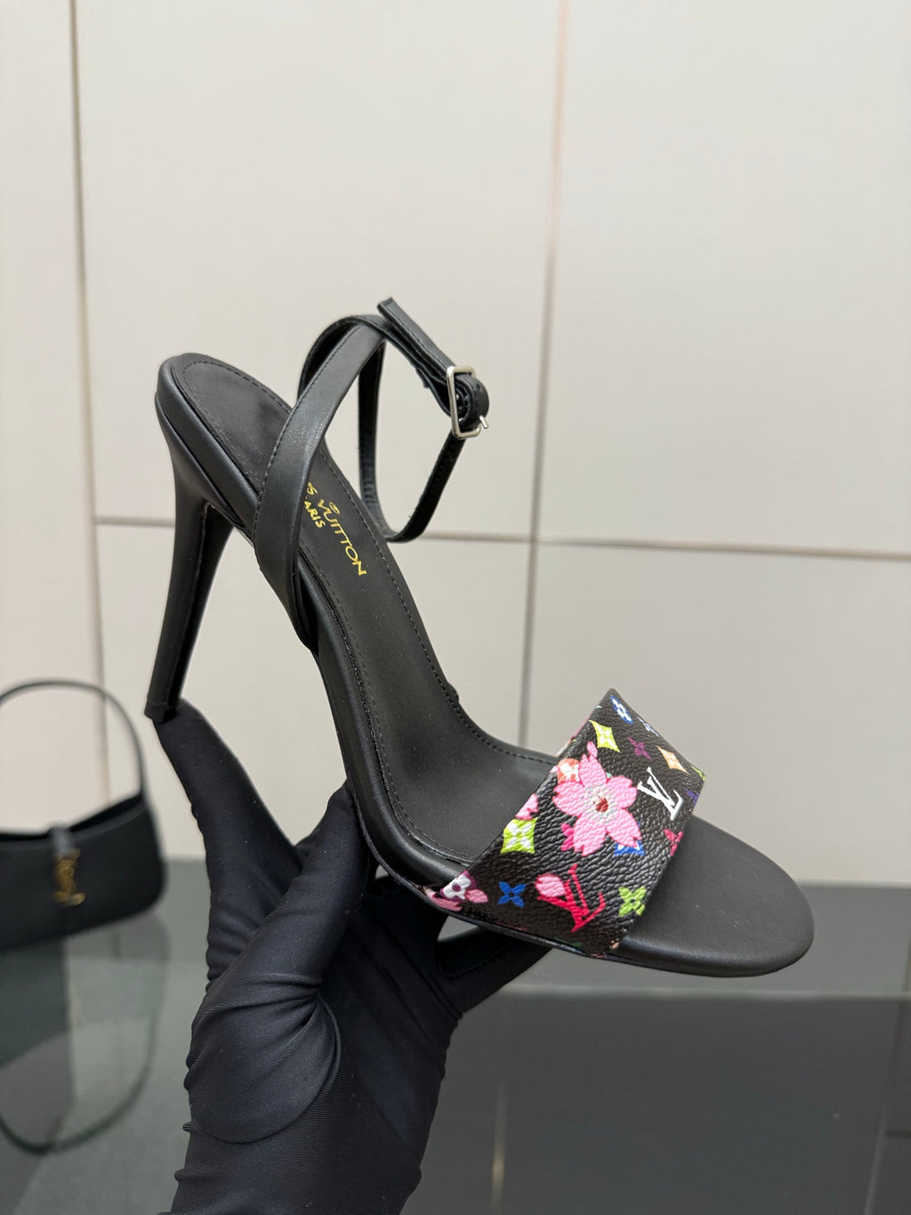 Black high-heel slingback sandal with multicolor floral monogram strap detail