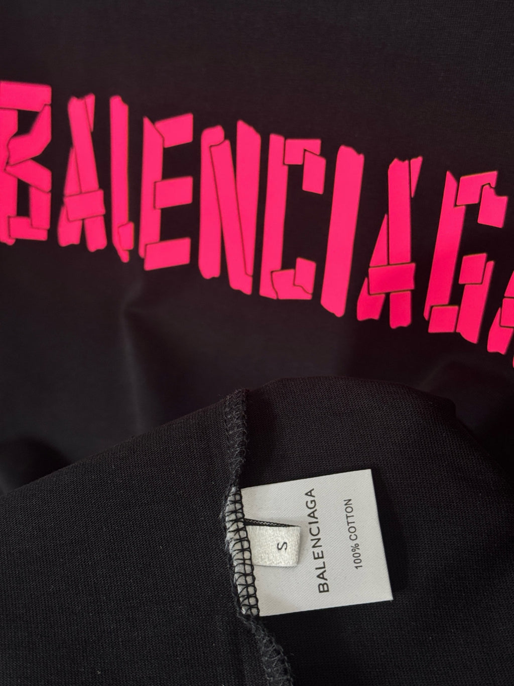 Black T-shirt with pink BALENCIAGA print and size label