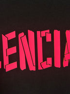 Black T-shirt with large pink BALENCIAGA lettering across front
