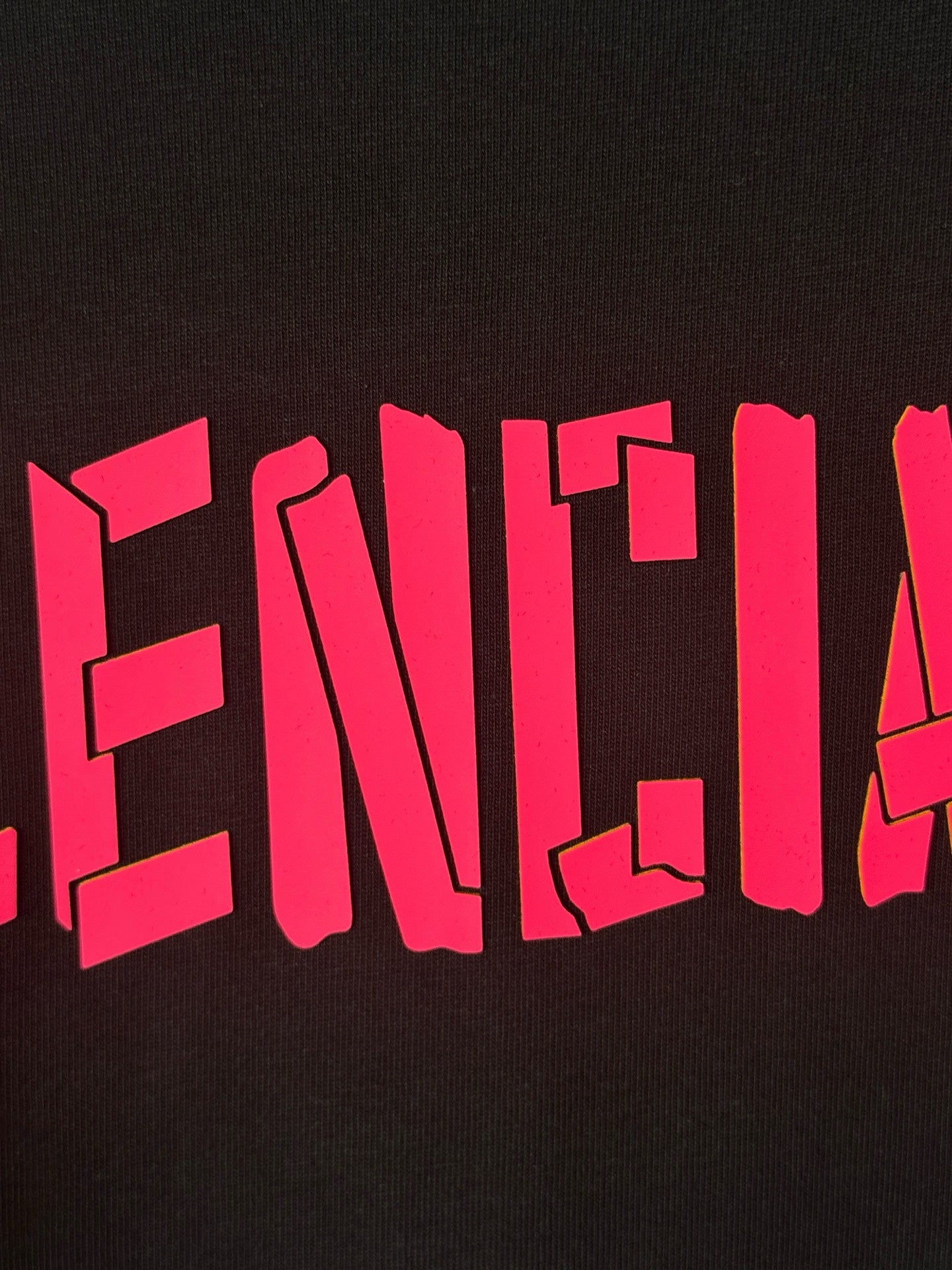 Black T-shirt with large pink BALENCIAGA lettering across front