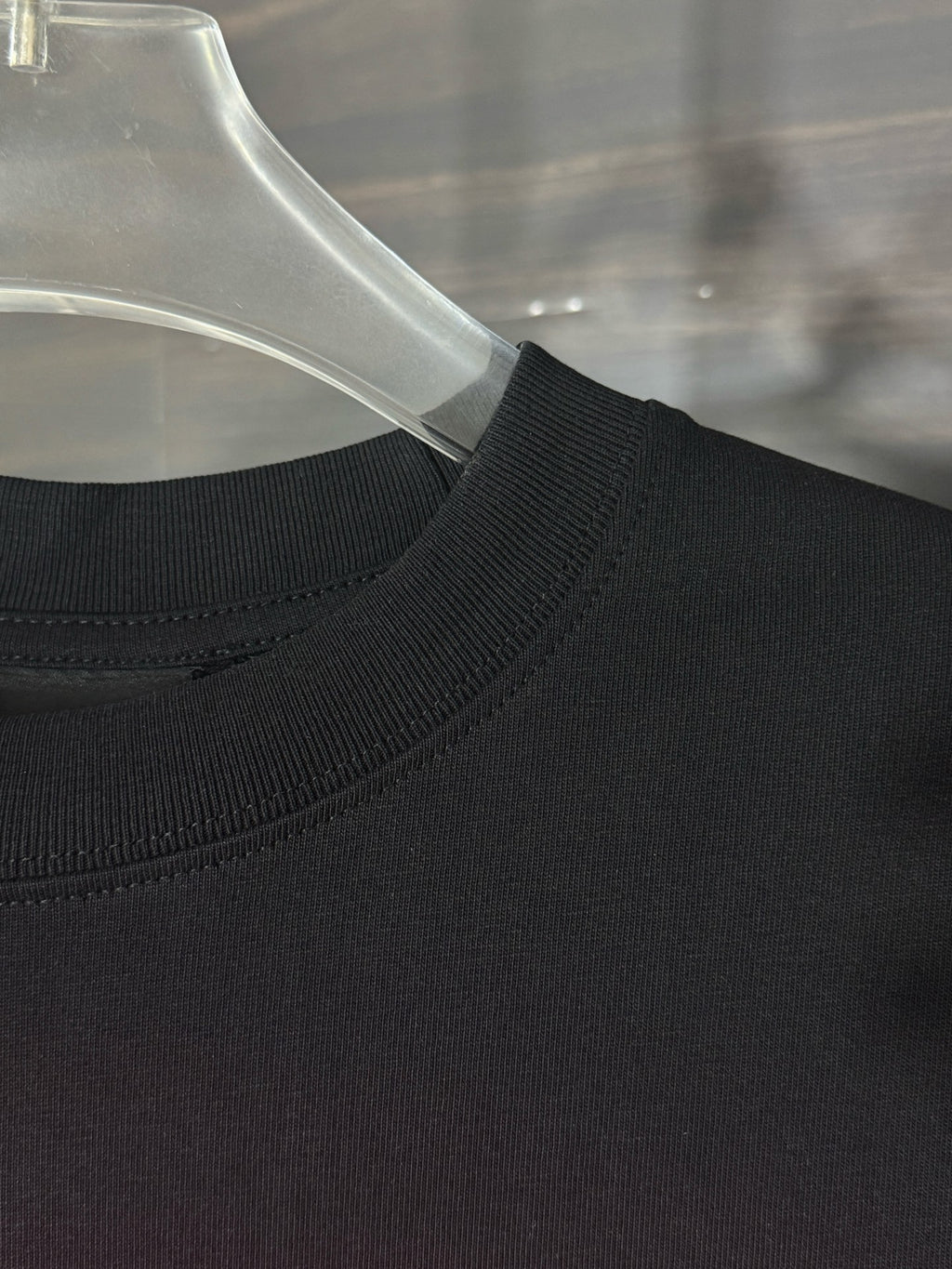Black T-shirt neckline with ribbed collar and stitched seam