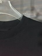 Black T-shirt neckline with ribbed collar and stitched seam