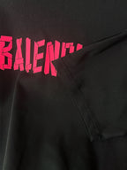 Black T-shirt with pink BALENCIAGA print and side seam detail