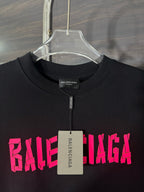 Black crewneck T-shirt with pink BALENCIAGA print and neck tag