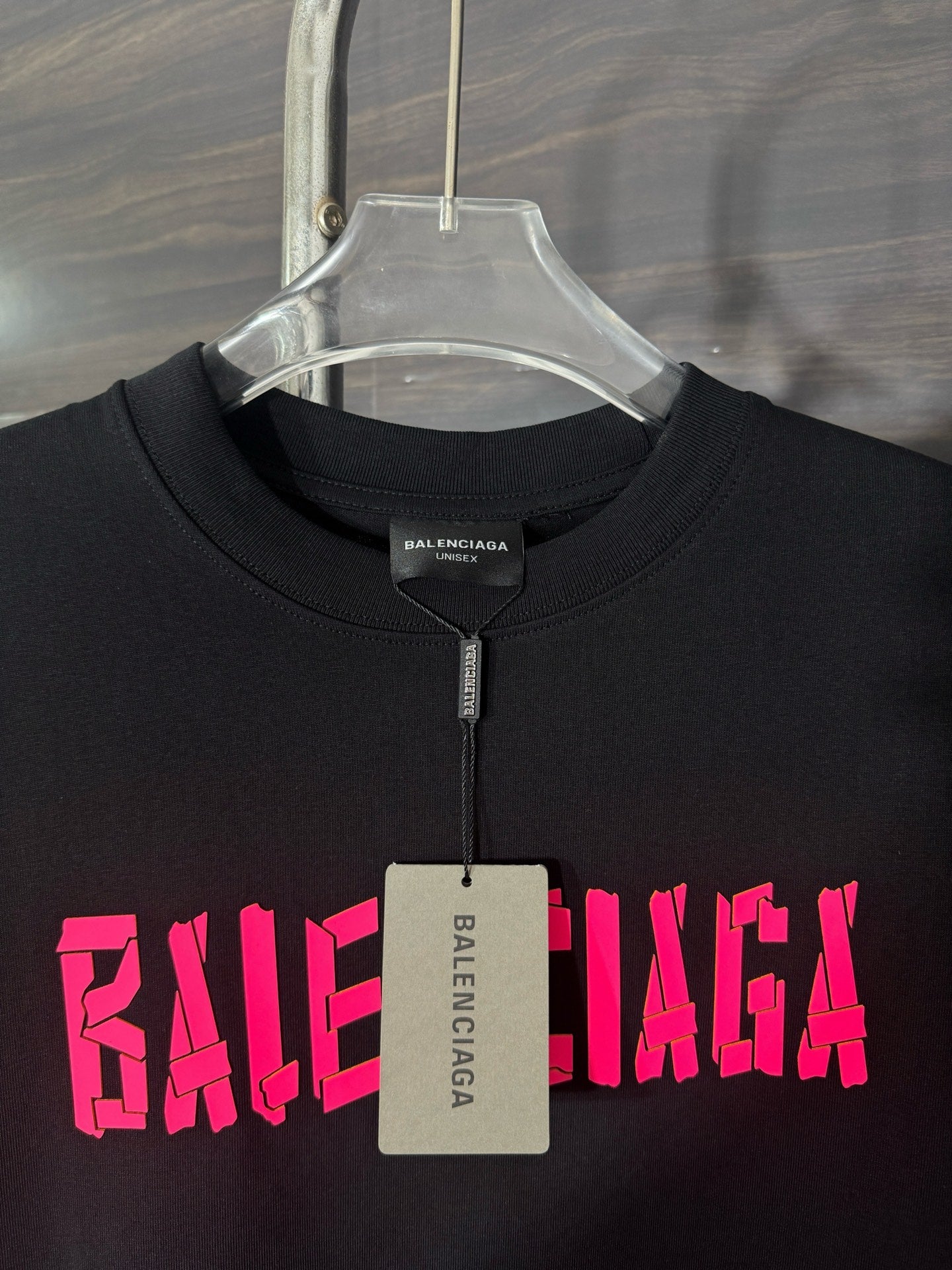 Black crewneck T-shirt with pink BALENCIAGA print and neck tag