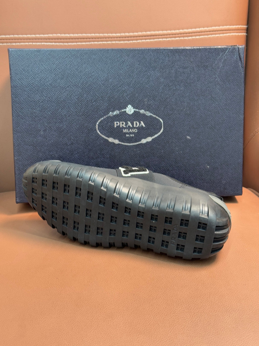 Prada unisex dark gray sneaker outsoles with square tread pattern.