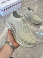 Moncler knit slip-on sneakers, light green, hand-held side view with logo