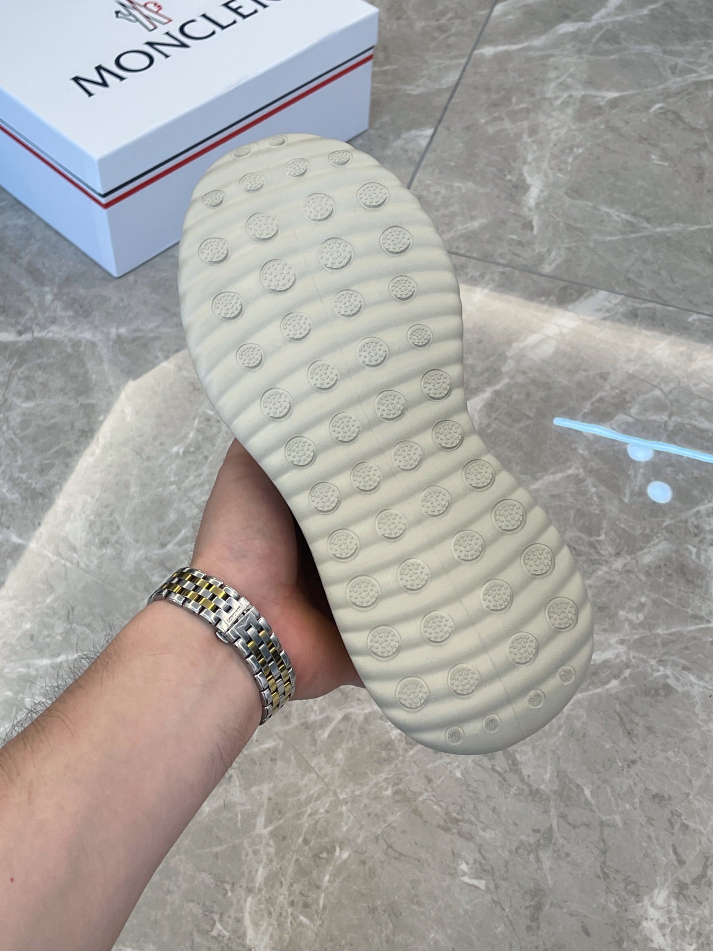 Moncler slip-on shoe sole, light green textured tread, close-up