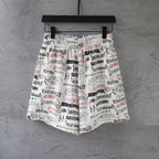Balenciaga printed shorts with elastic waistband and drawstring, white multicolor text