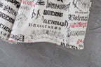 White printed shorts hem with black and red logo text, gathered look