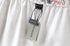 Balenciaga shorts with gray brand tag and black drawcord, white