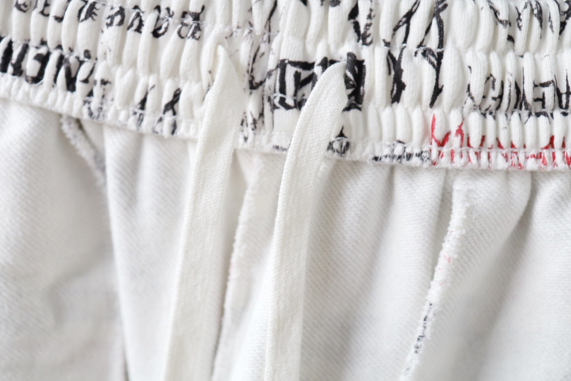 Elastic waistband close-up on white printed shorts with gathered stitching