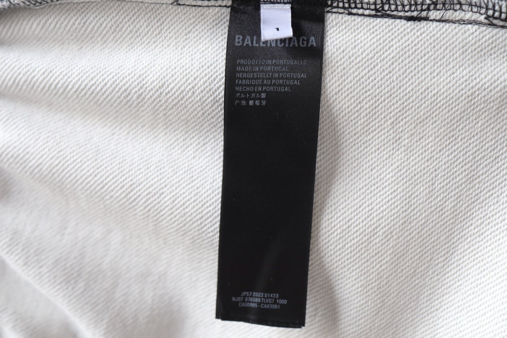 Balenciaga shorts with brand label on light-colored fabric panel.