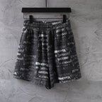 Balenciaga patterned shorts in black with white logo print and elastic waistband.