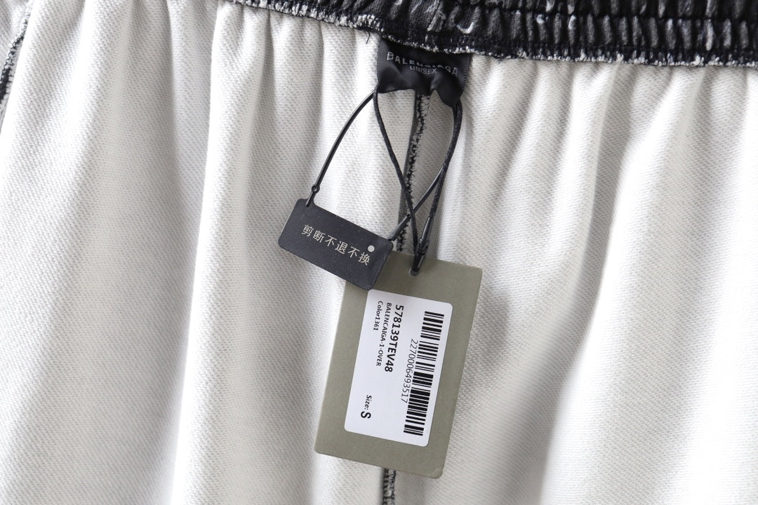 Balenciaga shorts with drawstring and brand tags on light-colored fabric.