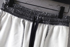 Balenciaga shorts waistband close-up: black elastic with white fabric panels.