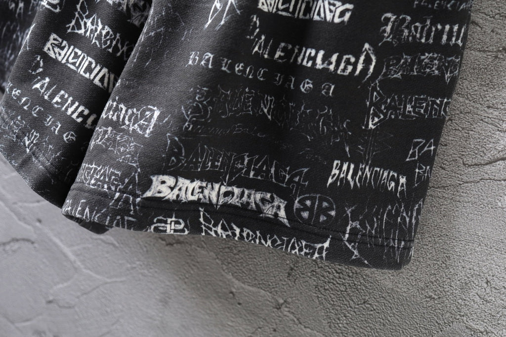 Balenciaga logo-print shorts with gathered hem and white lettering pattern.