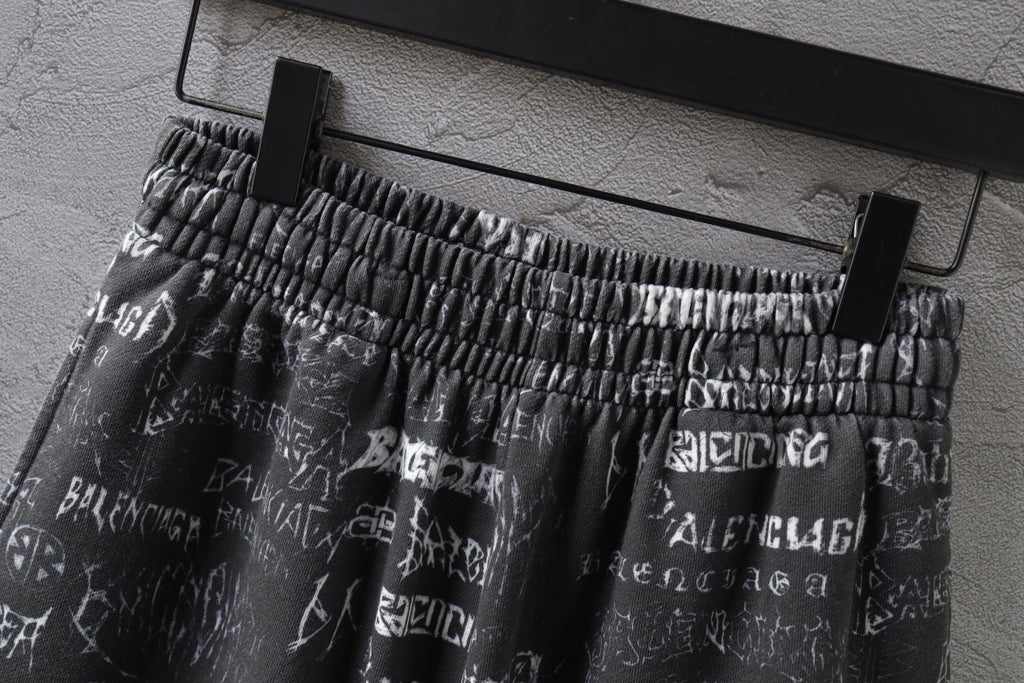 Balenciaga patterned shorts on hanger, elastic waistband and white logo print visible.