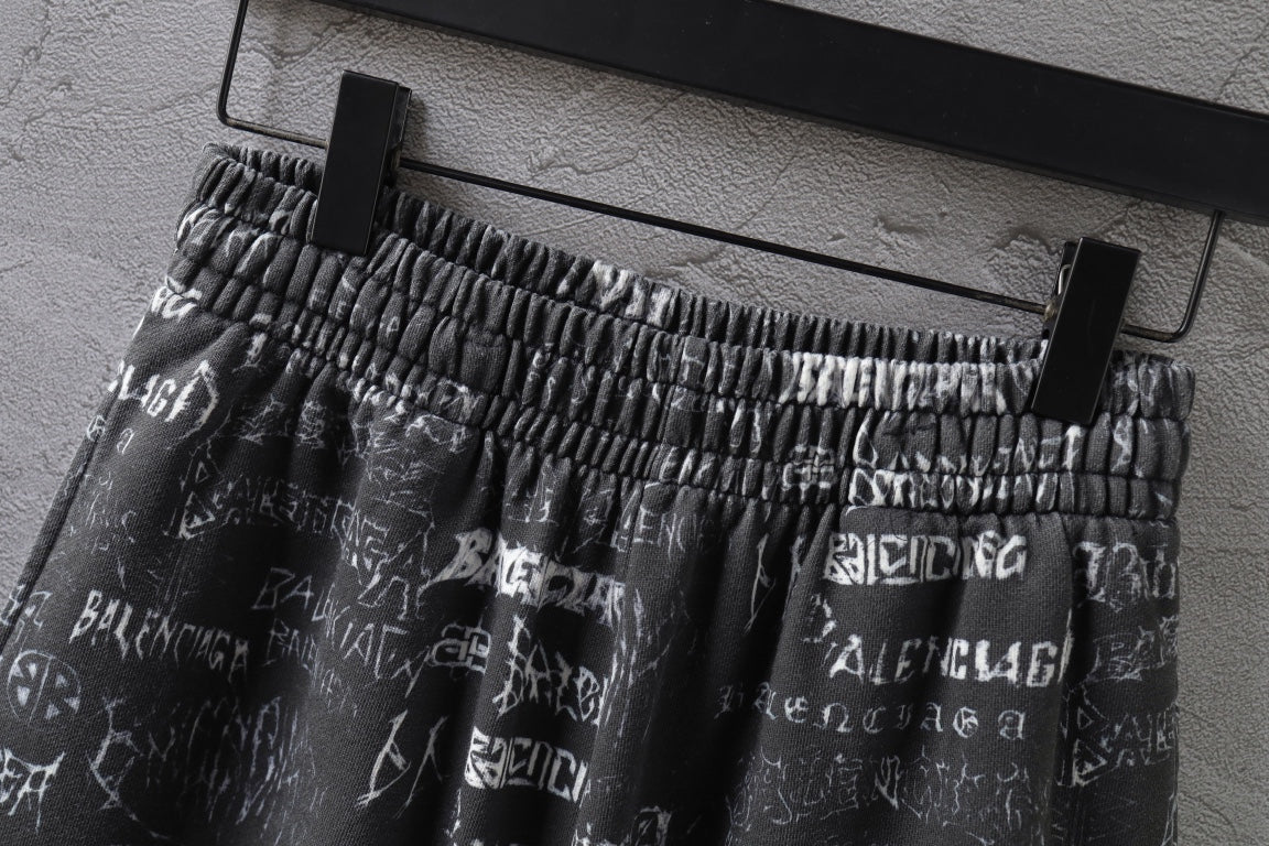 Balenciaga patterned shorts on hanger, elastic waistband and white logo print visible.