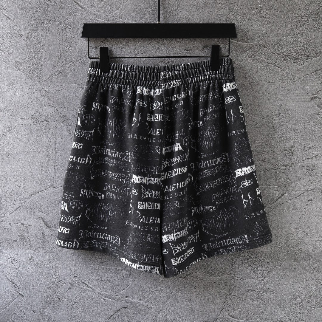 Balenciaga patterned shorts with allover white logo text and elastic waist, front view.