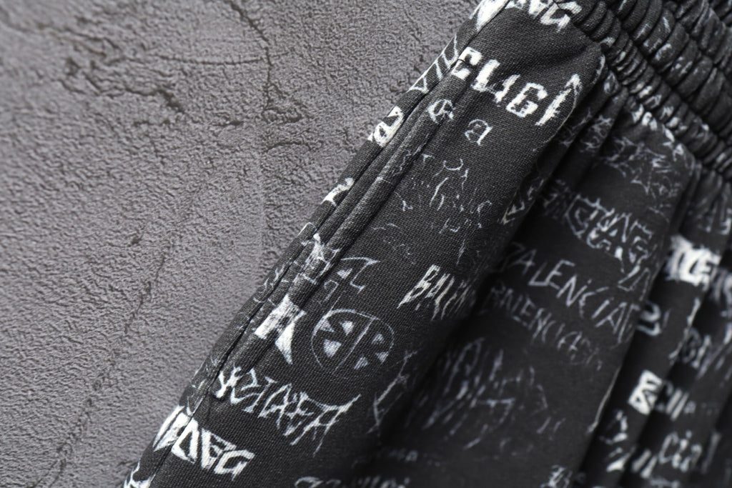 Balenciaga logo-print shorts fabric close-up with elastic waistband.