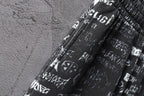 Balenciaga logo-print shorts fabric close-up with elastic waistband.