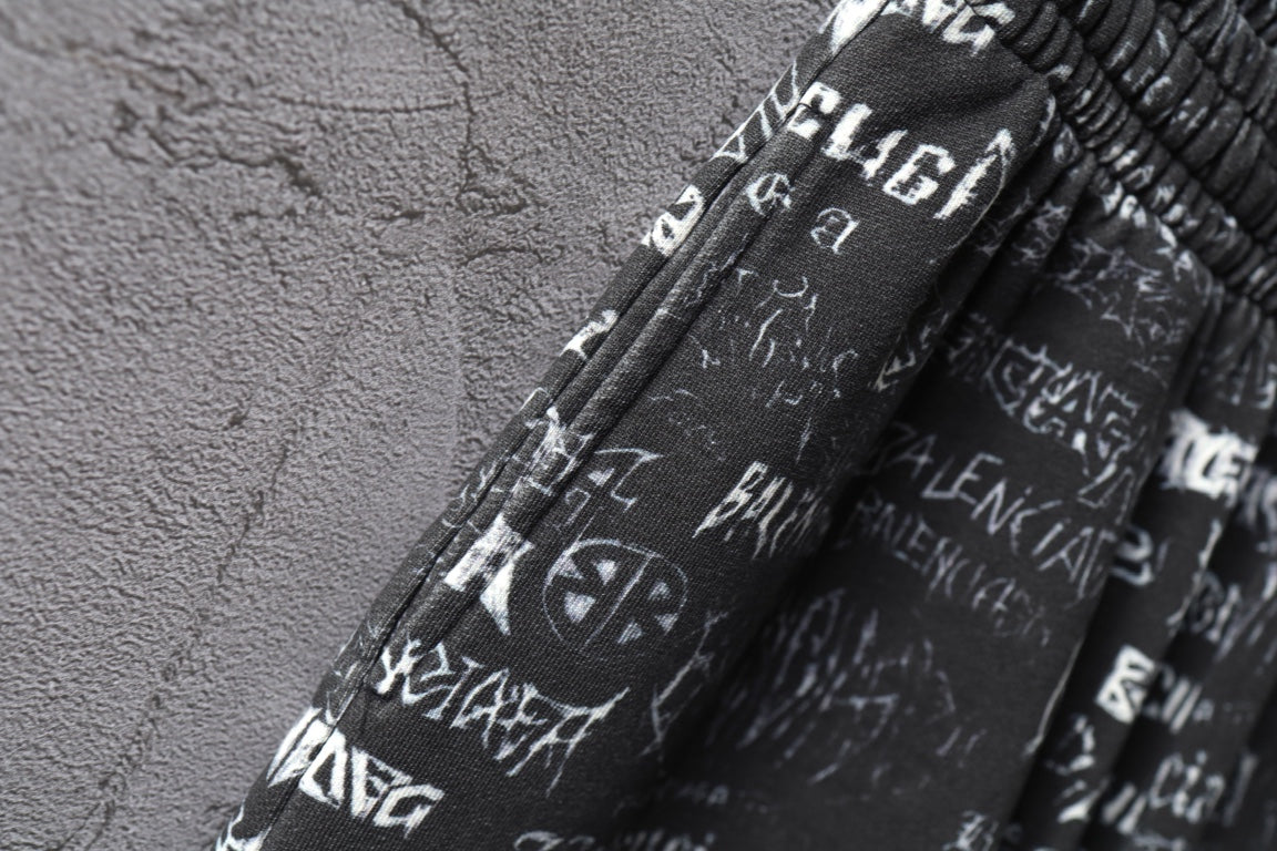 Balenciaga logo-print shorts fabric close-up with elastic waistband.