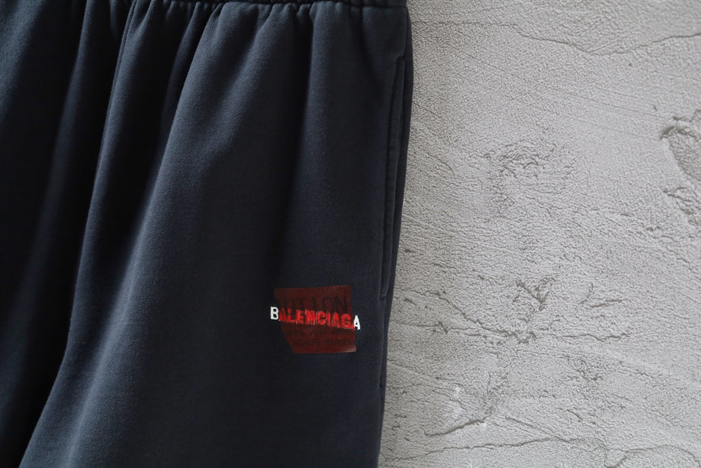 Dark navy shorts with red Balenciaga logo label on side